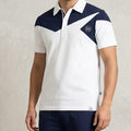 Man wearing a white and navy sports outfit with a logo on a plain background