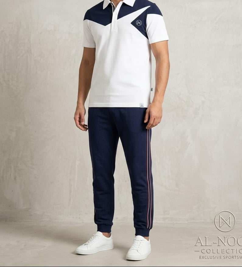 Man wearing a white and navy sports outfit with a logo on a plain background